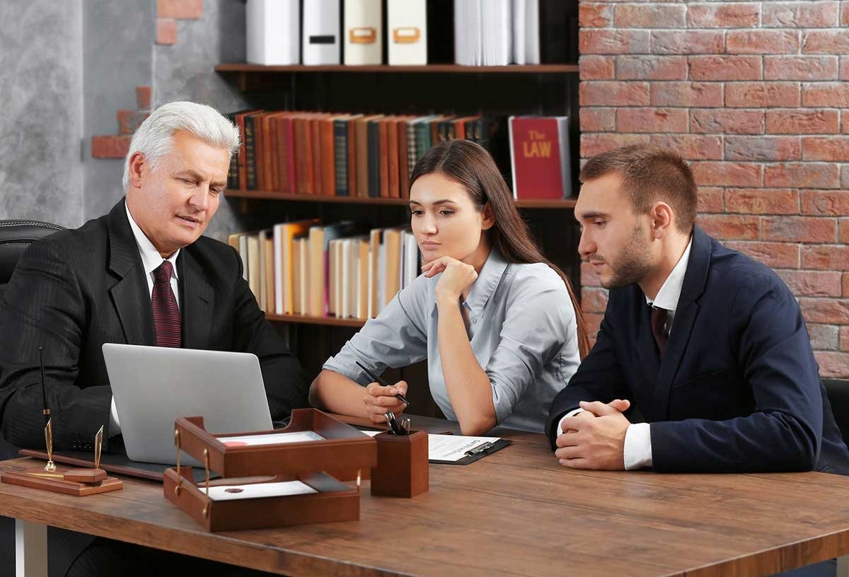 Couple discussing power of attorney with a lawyer